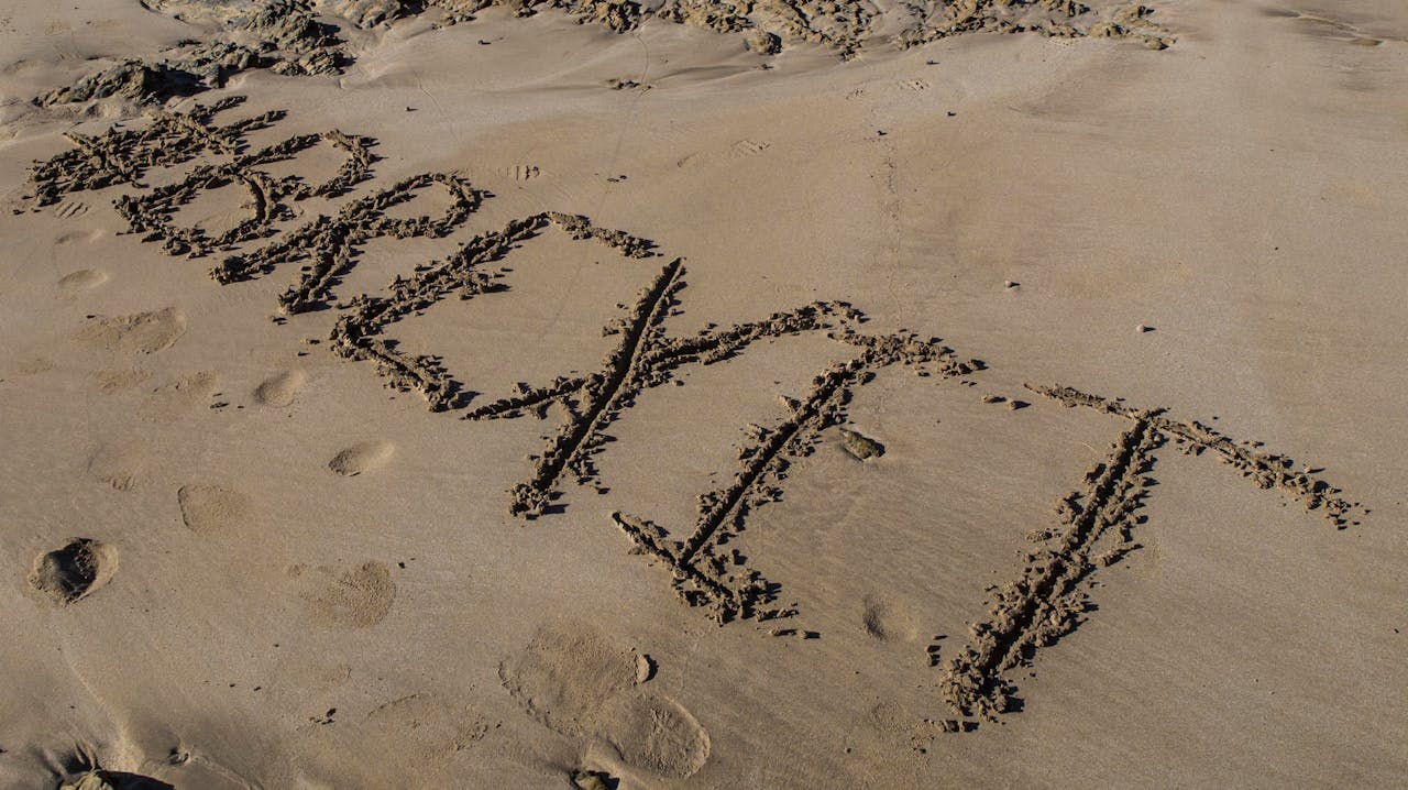 image of Brexit written in the sand