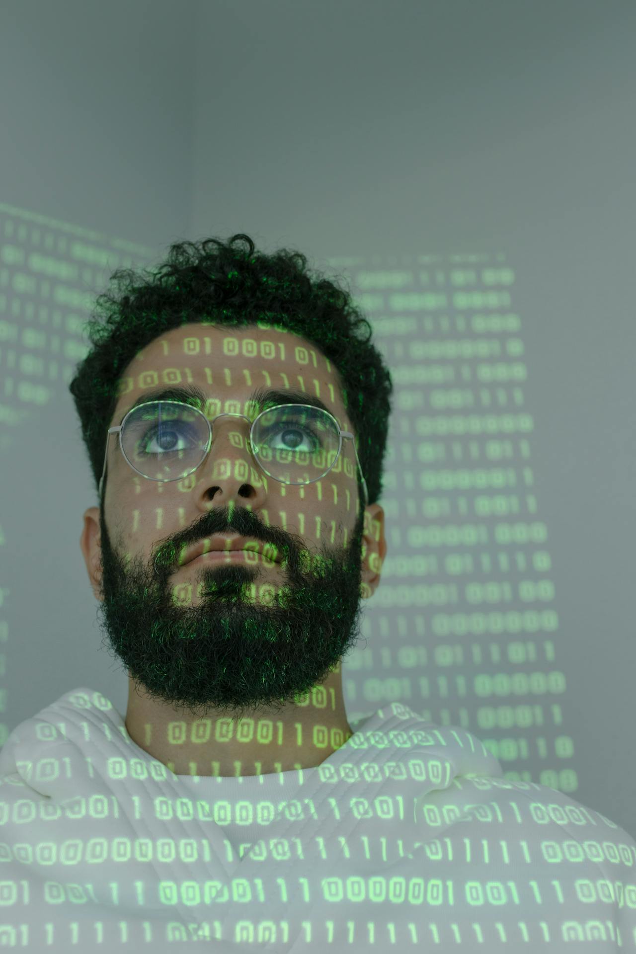 image of a person with rows of data code reflected on his face
