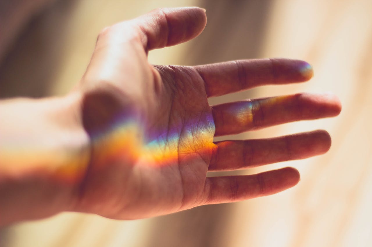 image of a hand with a rainbow on it