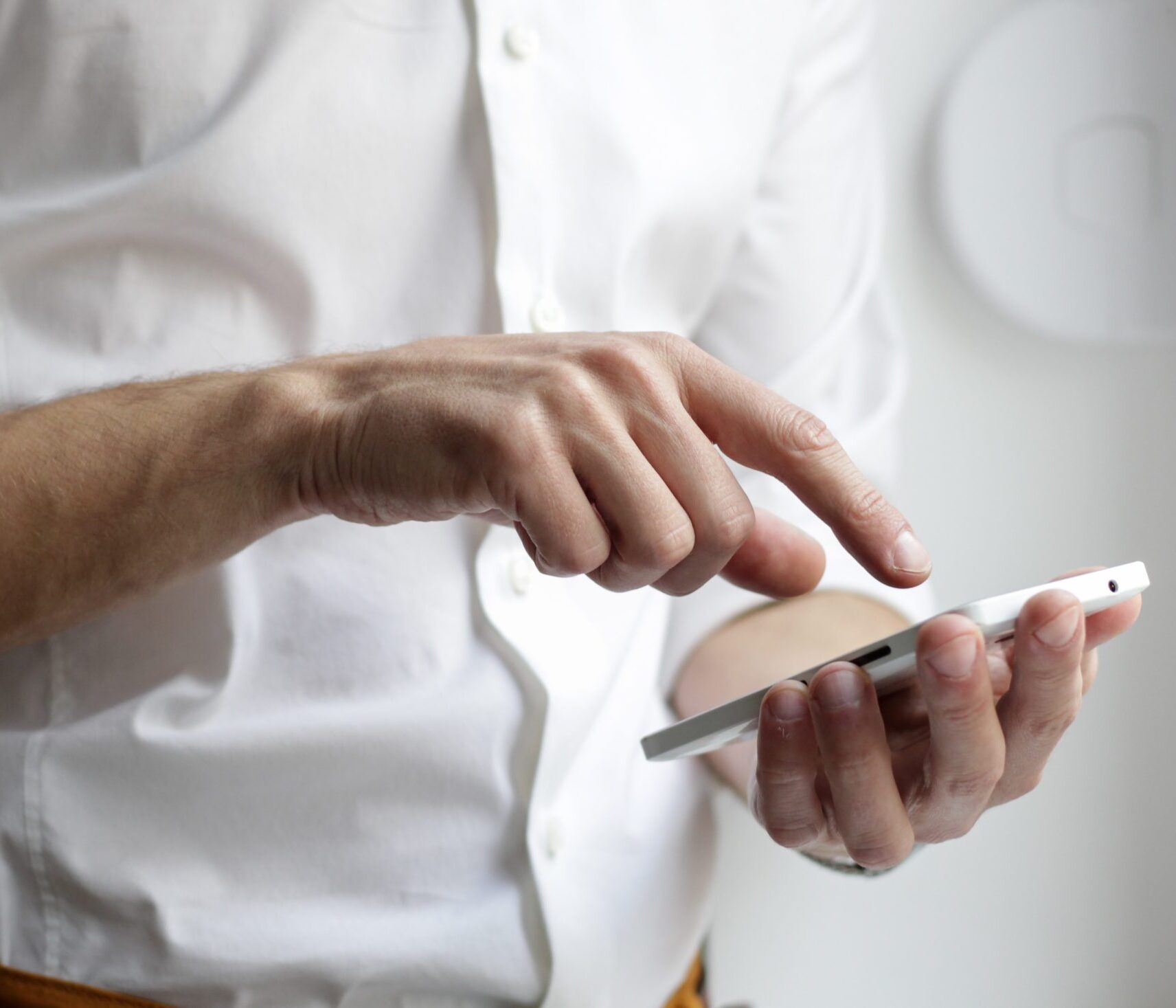 image of a business person holding a phone heading EM Law page about Whistleblowing, Employment Law, Employment Lawyers, Whistleblowing policies solicitors