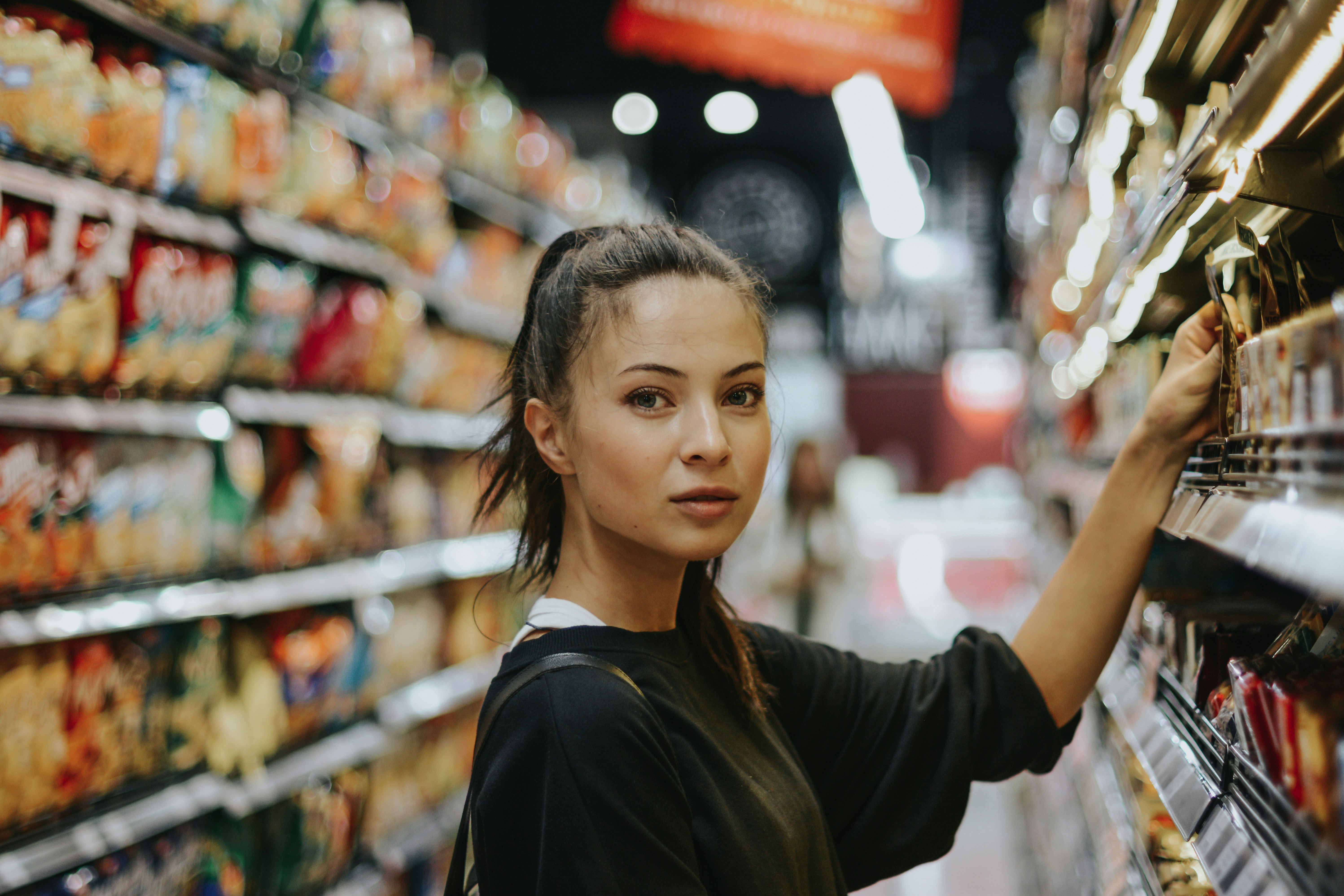 image of a woman consumer inside a store heading EM Law article about upcoming updates to consumer law following the Digital Markets, Competitions and Consumers Act 2024