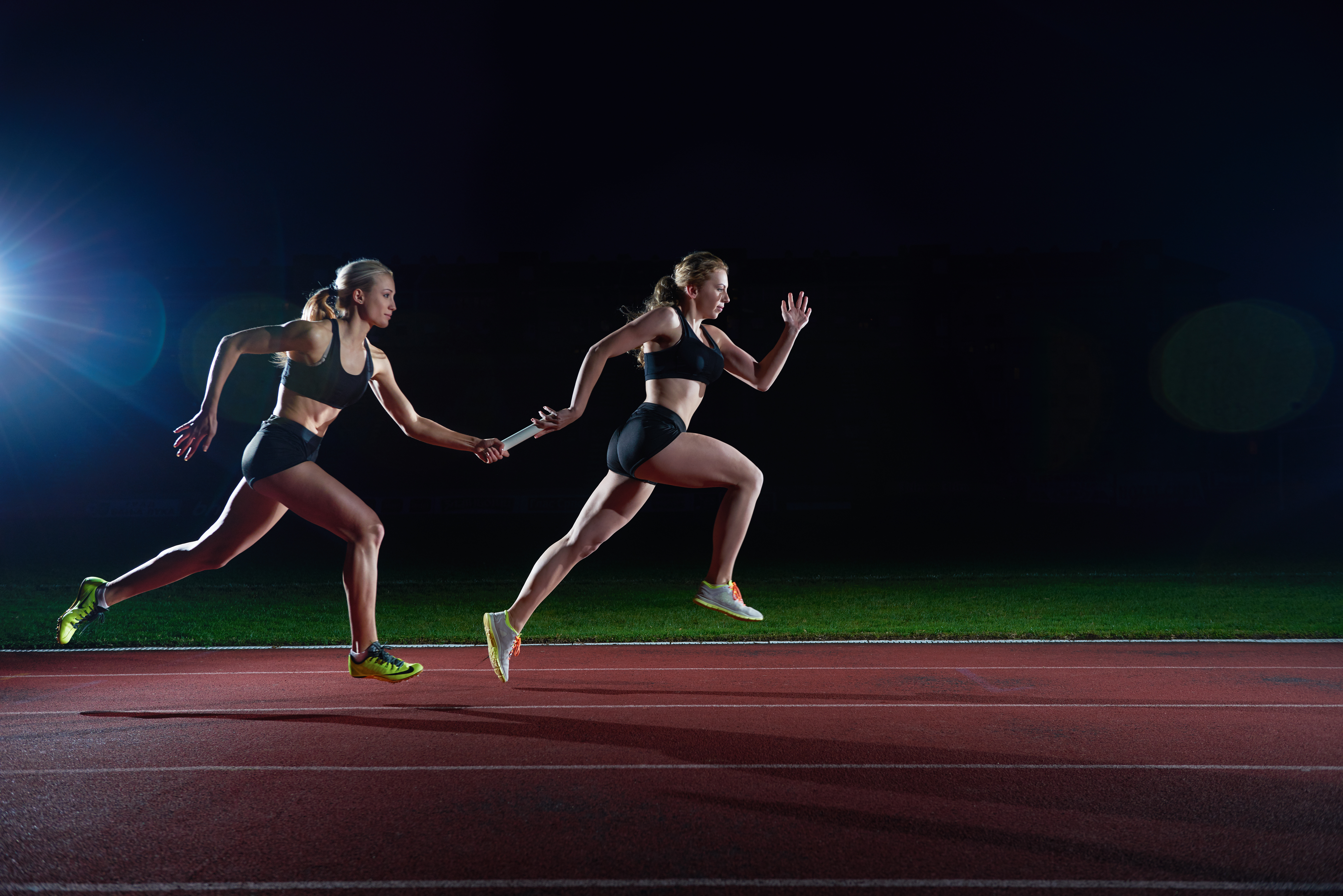 Woman athletic runners passing baton in relay race heading an article by EM Law about Novation (photo by vecteezy)