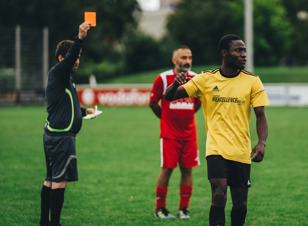 image of a referee showing a red card to a football player in an article by EM Law about EU GDPR data transfer breach