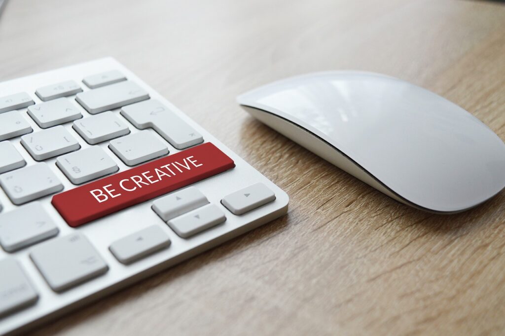 image with a keyboard and a mouse with a key saying Be Creative inside an article about Copyright by EM Law 