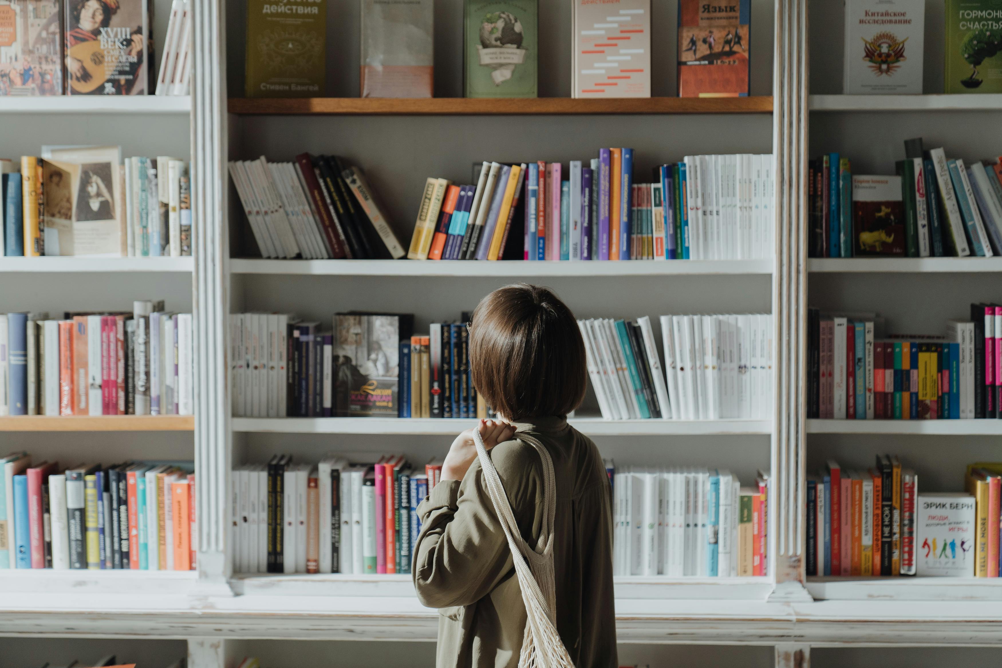 image showing a woman looking at a library bookshelves full of books inside an article by EM Law about copyright