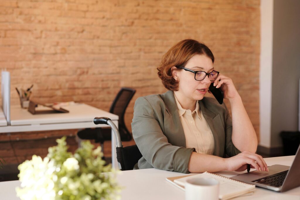 image of a woman at work making a call inside EM Law article about new UK Bill and cyberattacks regulations