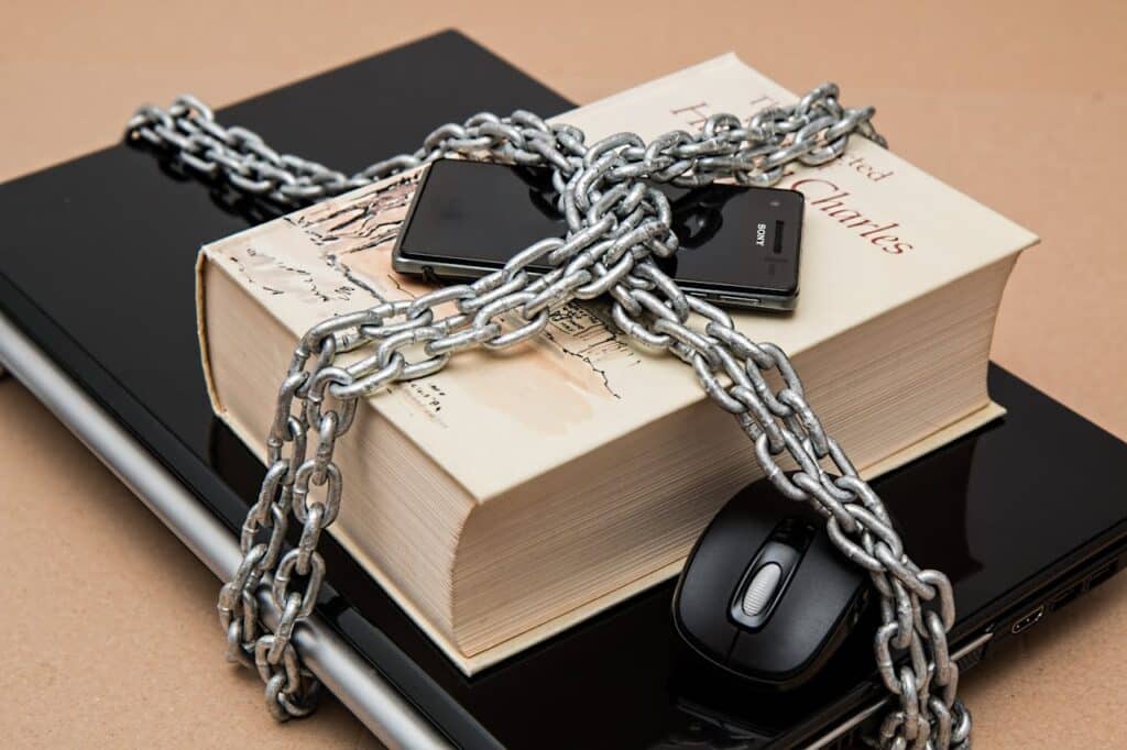 image of a laptop, mobile and a book chained up inside an article by EM Law about data protection agreement DPA