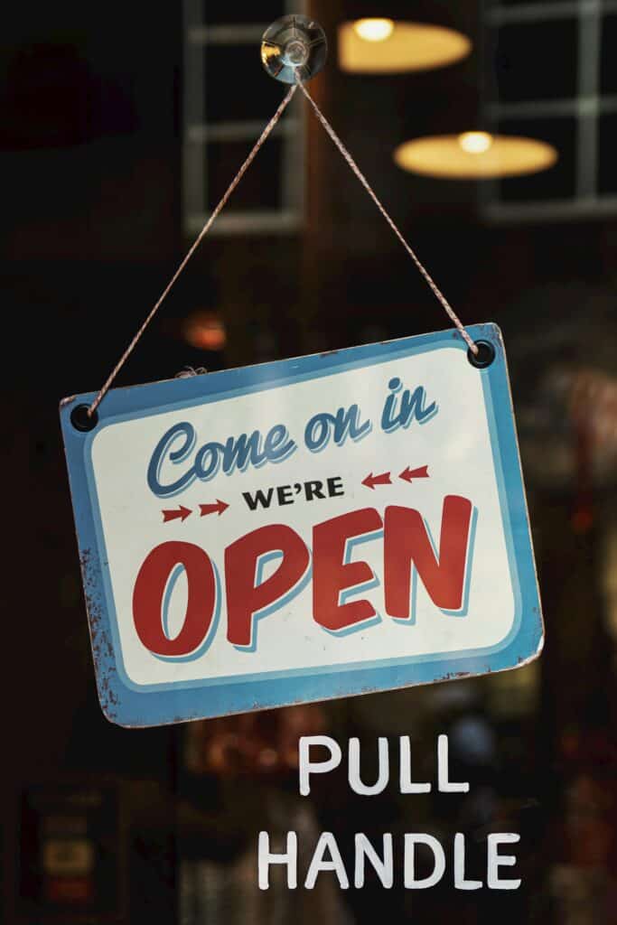 image of business with a open sign on doors inside an article by EM Law on the state of SMEs in the UK market