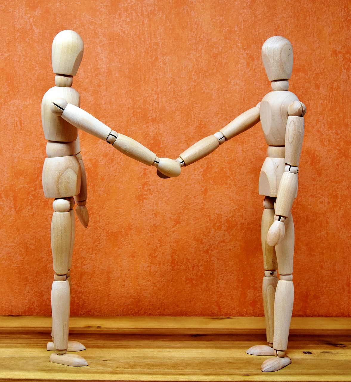 image of two figurines shaking hands heading EM Law case study