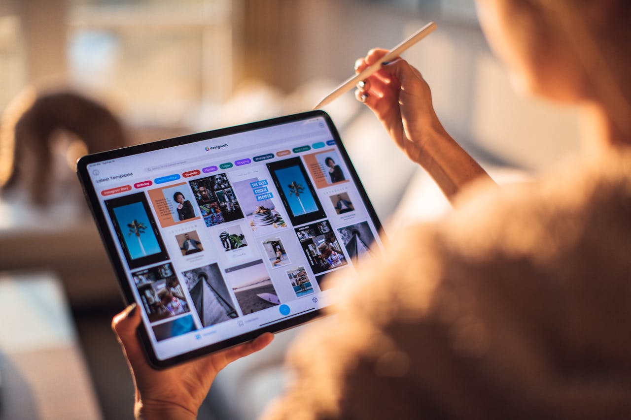 image of a woman holding a tablet showing ad images - heading an article by EM law about Ad-Tech