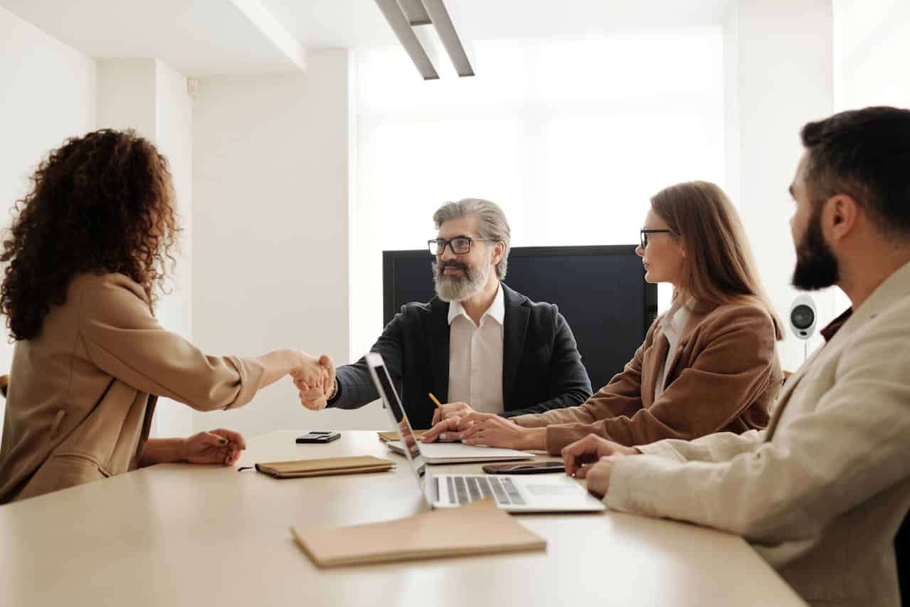 image of employees at the table heading an article by EM Law about LTIP