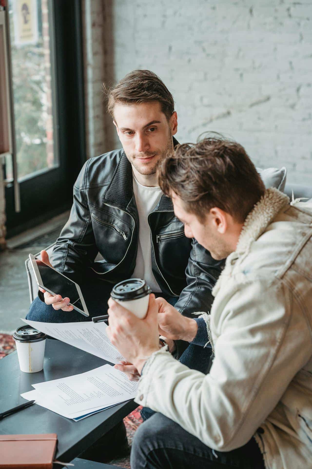 image showing two men looking over documents over coffee heading an article by EM Law about MOU