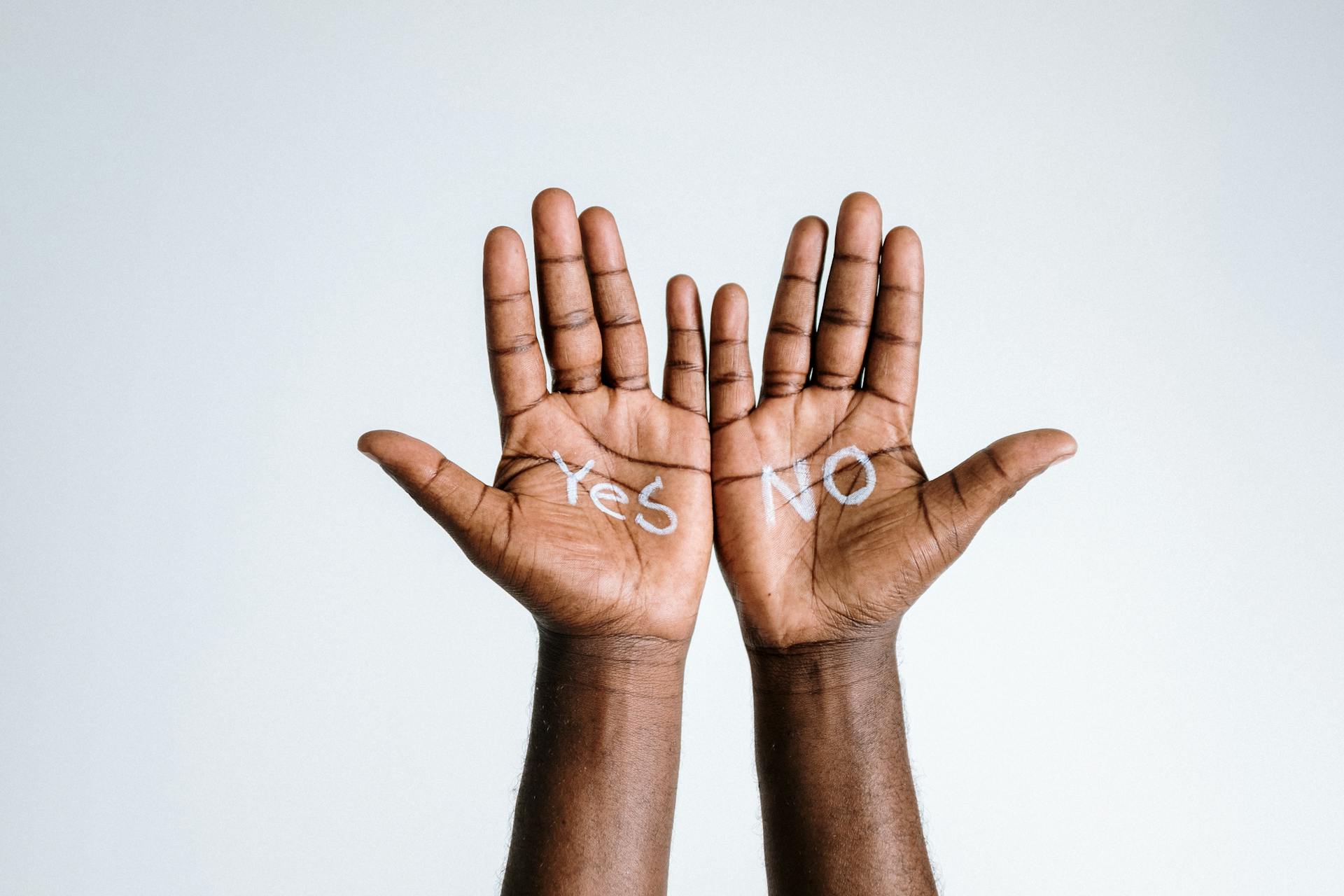 image of hands with written yes and no heading an article about Consent or Pay