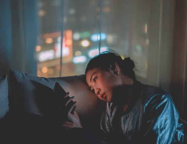 image of a woman on the phone at night heading an article by EM Law on Direct Marketing and Facebook law case