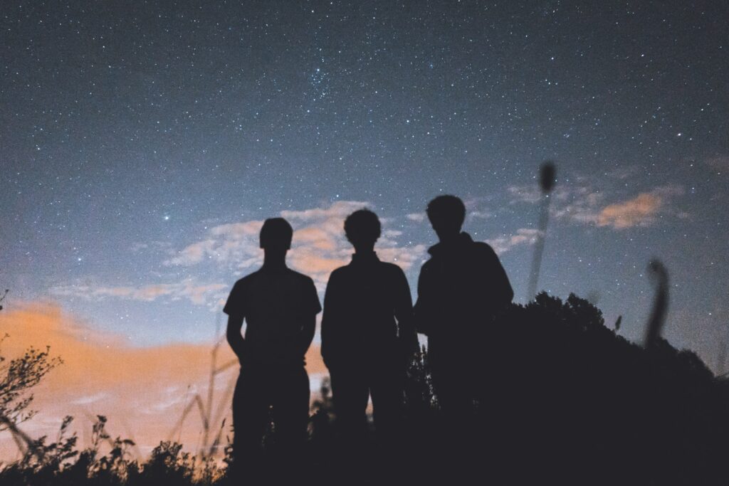 image of three people staring at the sky