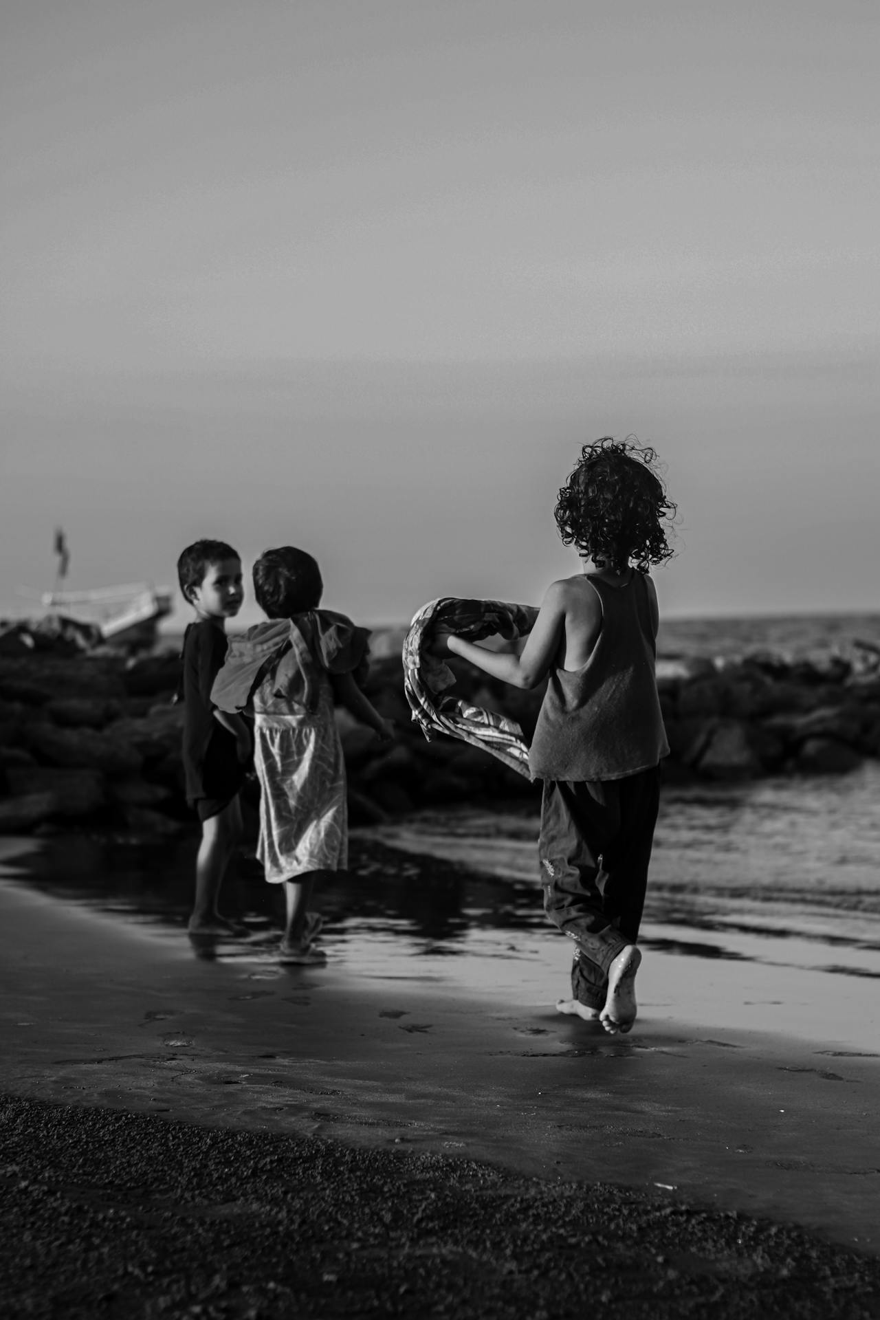 a third child chasing a duo of children on the beach inside an article about third party rights by EM Law