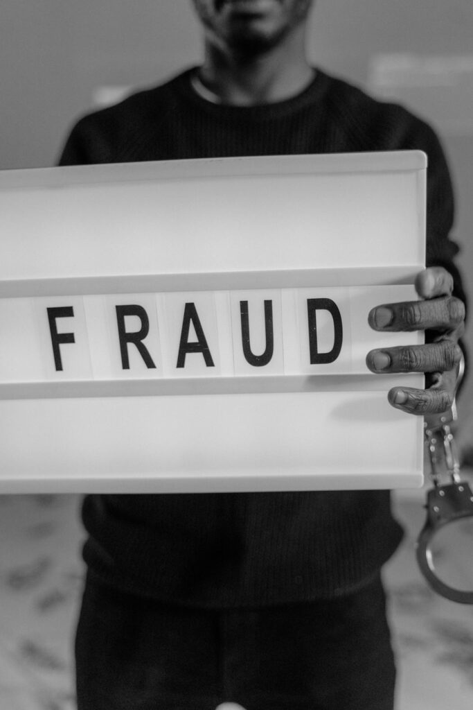 image of a man holding a fraud sign 