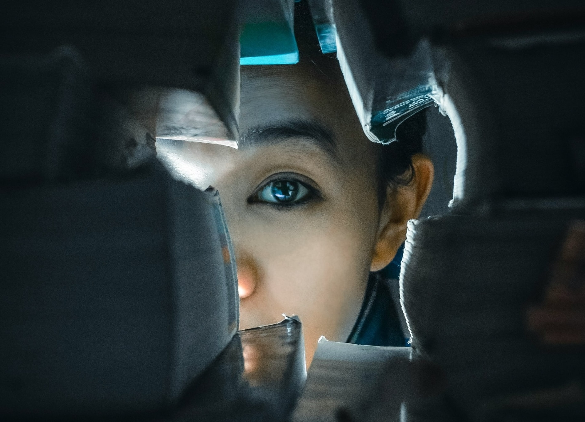 a woman staring through a gap