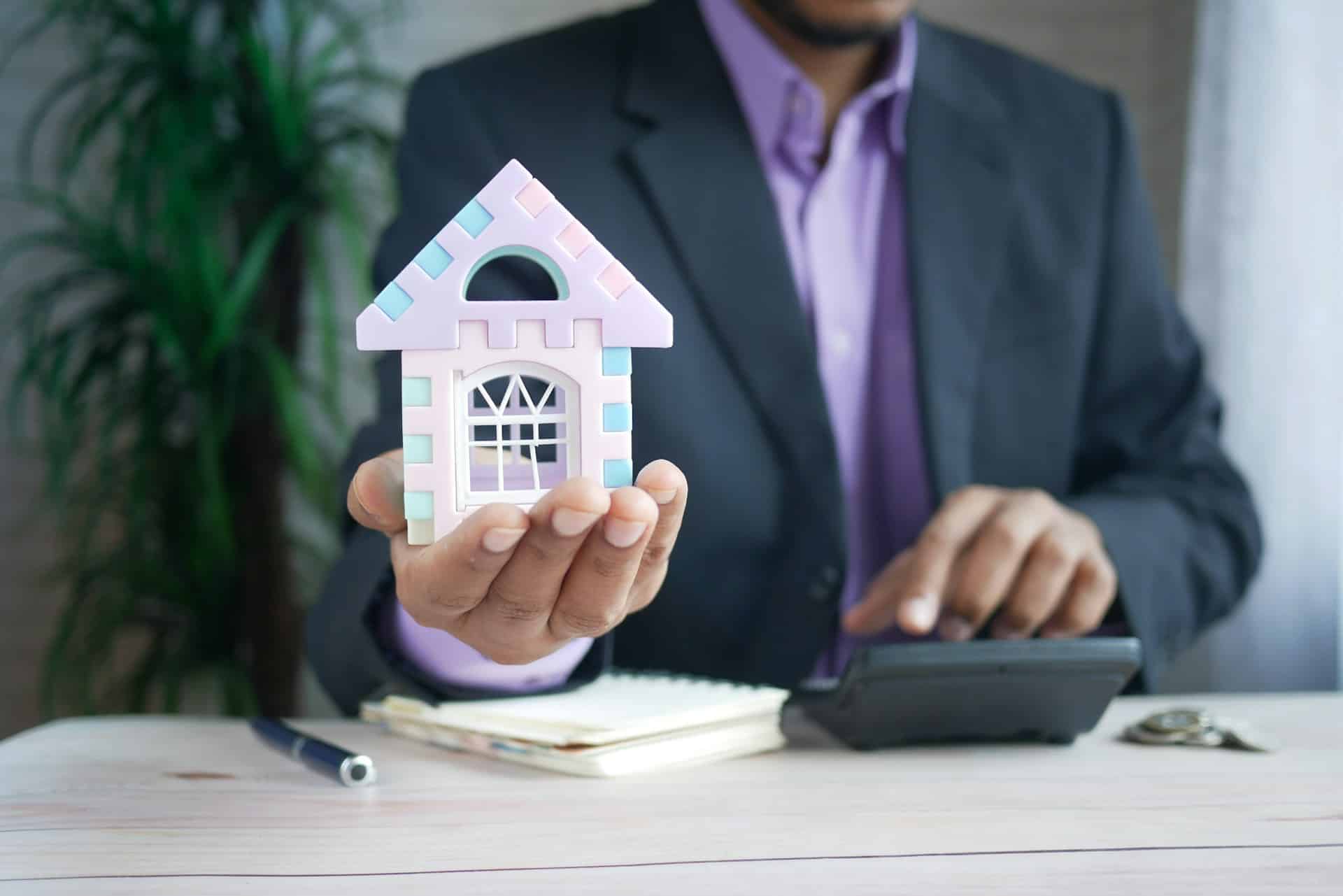 image a man holding a property in his hand