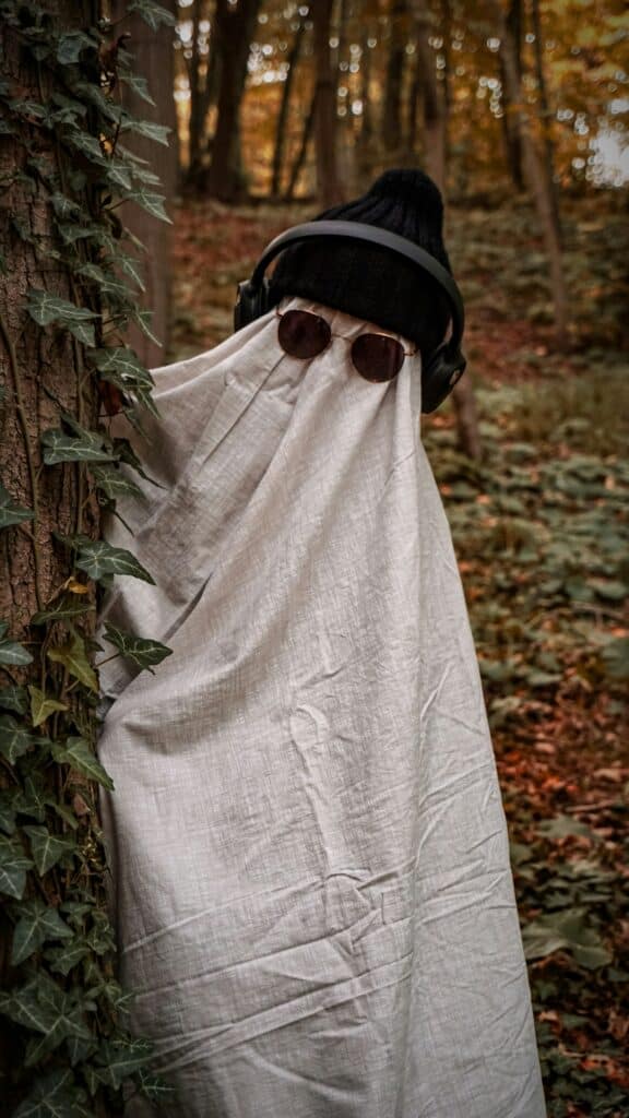 image of a person covered with a white sheet wearing glasses