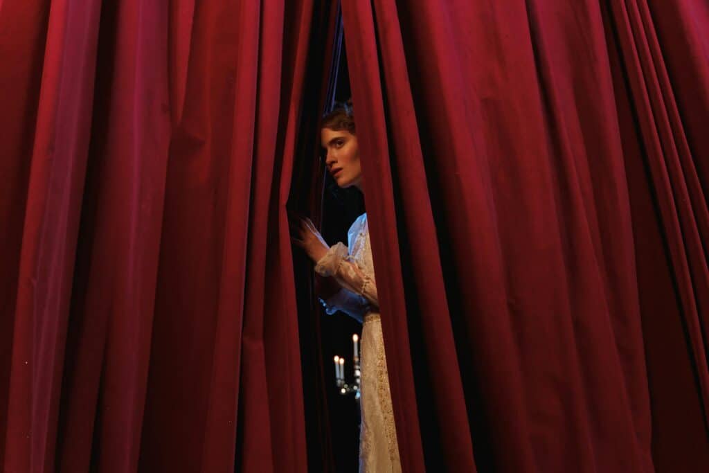a woman behind a curtain - representing implied terms