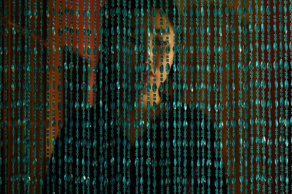 image of a woman behind a curtain