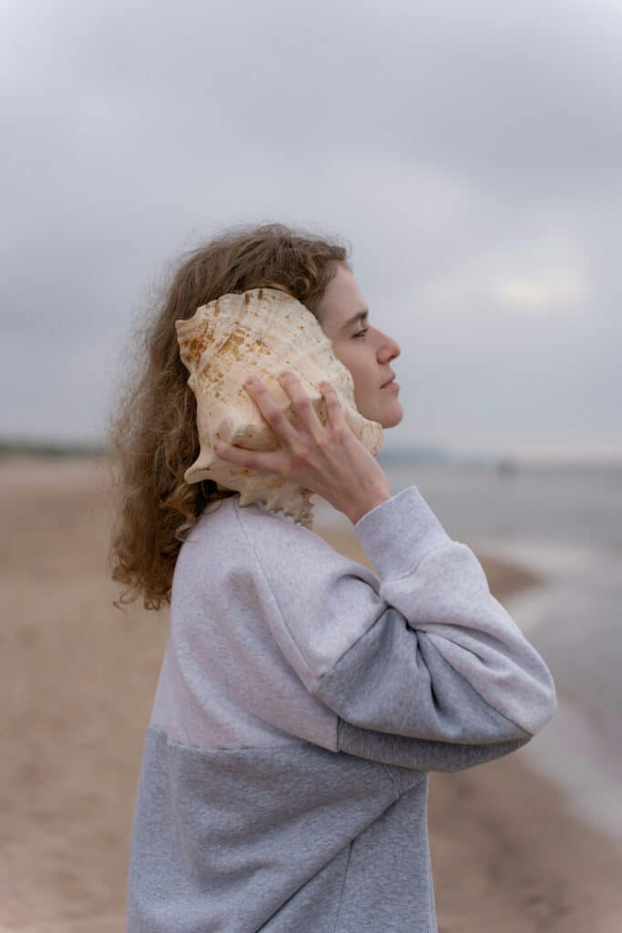 image of a woman with a shell next to her ear