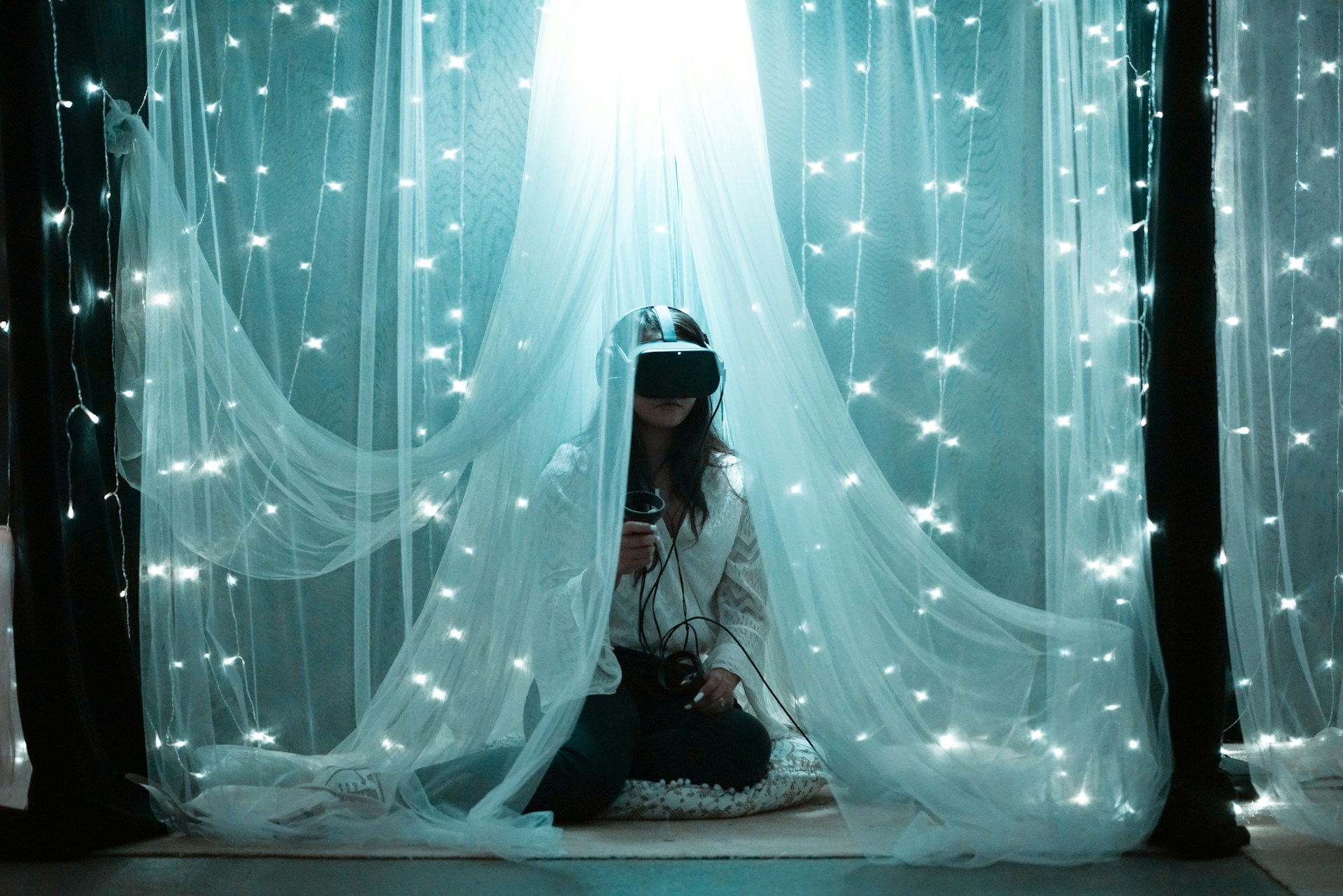 image of a person using headset with fairy lights above