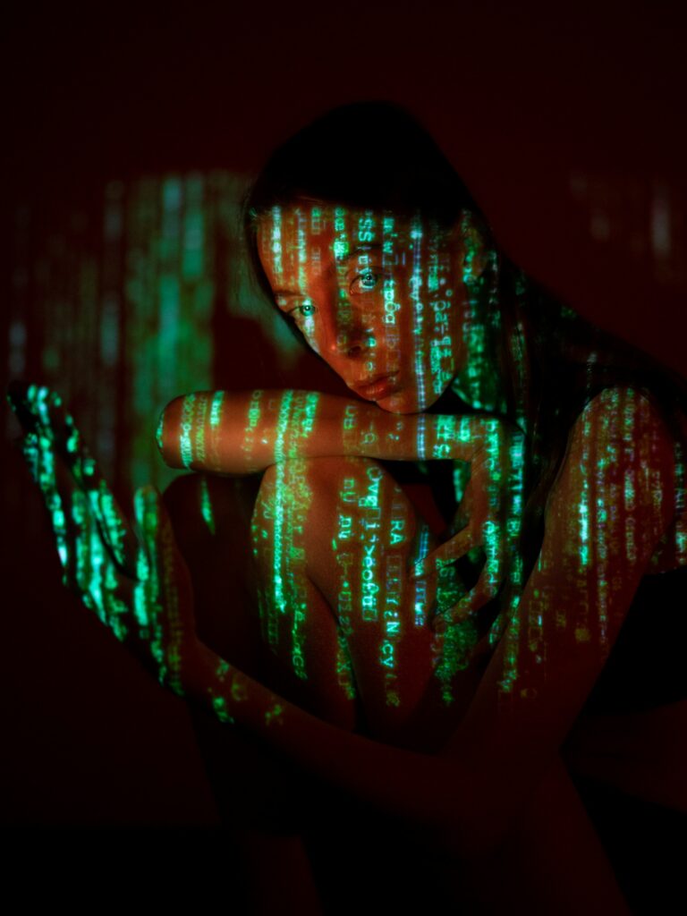 image of a woman with code reflected on her face