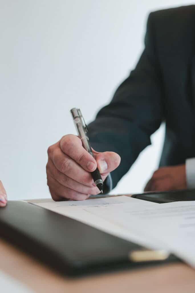 Businessman signing a contract EM Law