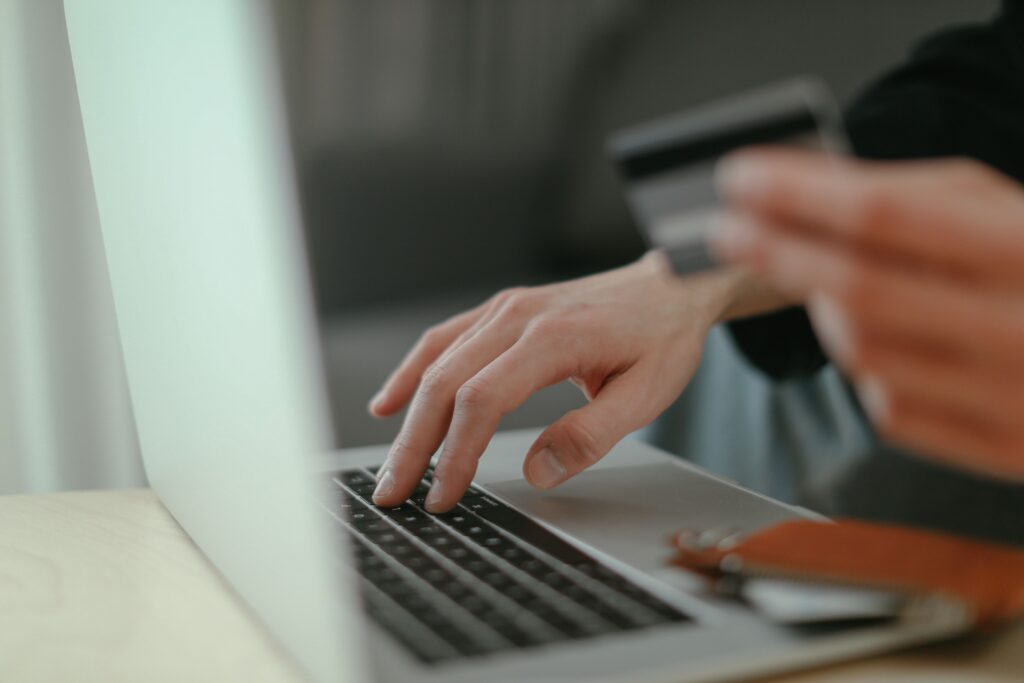 Photograph of person paying online in an EM Law blog about AI disclaimers.