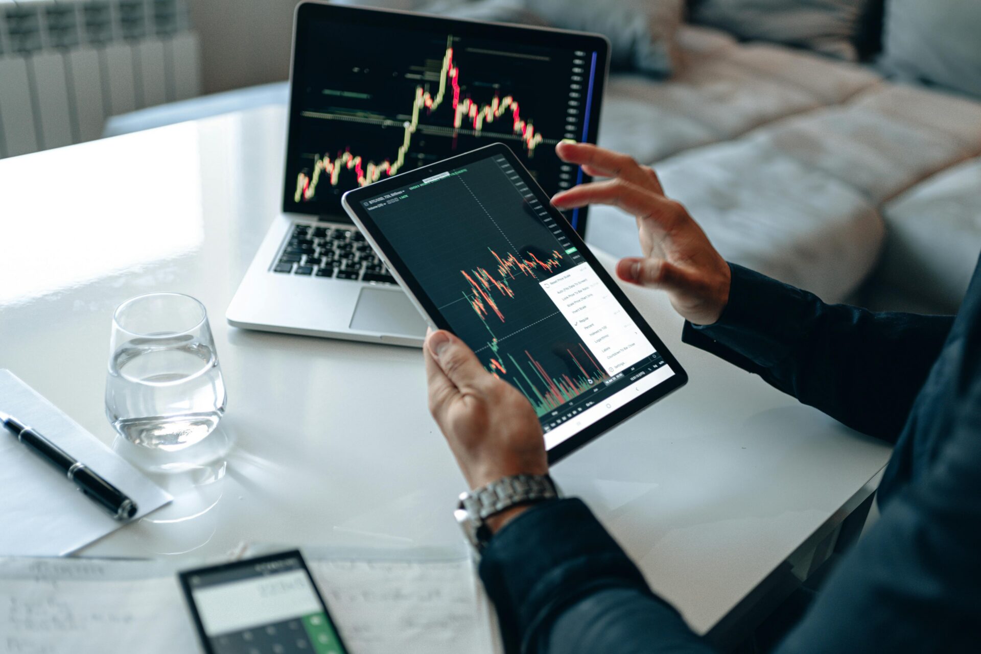 Man analysing stocks and shares line graph EM Law