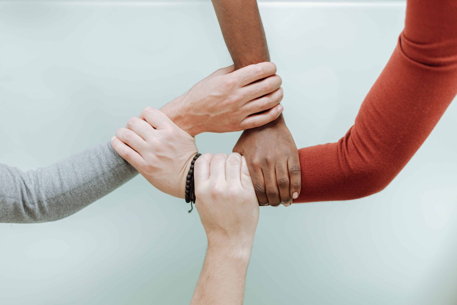 Arms linked together collaboratively, almost as if in a Joint Venture